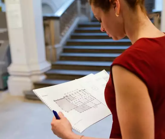 Woman looking at a floor plan
