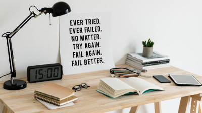 Desk with Poster saying Ever Tried, Ever Failed, No Matter, Try again, Fail Again, Fail Better