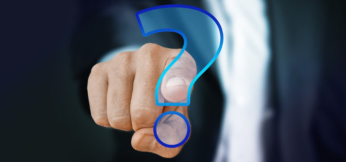 Business Person pointing to a question mark